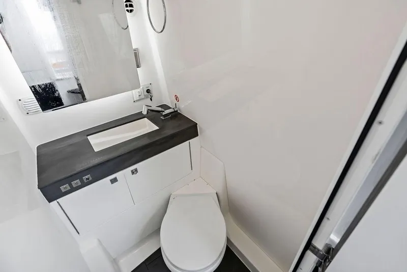 Slide: The Image of 2022 Aviara AV40 OB bathroom with modern sink and toilet design. - 23