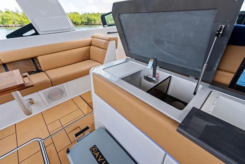 Slide: The Image of 2022 Aviara AV40 OB boat interior with tan seating and built-in sink. - 28