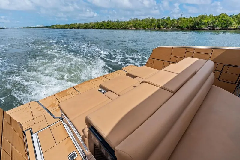 Slide: The Image of 2022 Aviara AV40 OB boat with tan seating, cruising on a scenic waterway. - 31