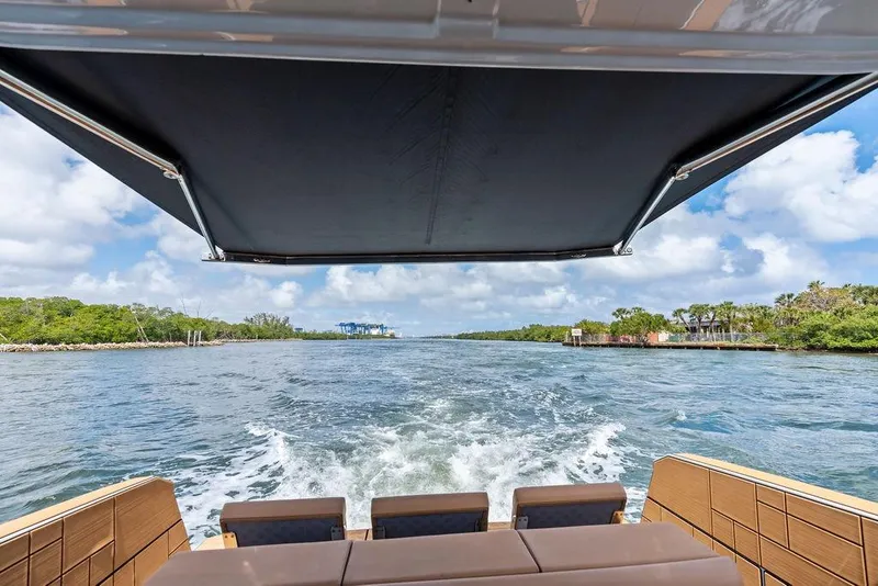 Slide: The Image of Aviara AV40 OB 2022 cruising on a scenic waterway under a sunny sky. - 34