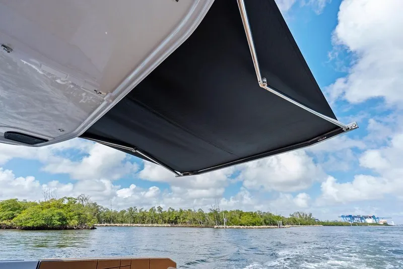 Slide: The Image of 2022 Aviara AV40 OB boat with extended canopy on a scenic waterway. - 35