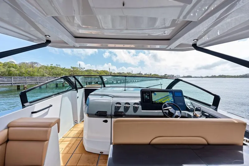 Slide: The Image of 2022 Aviara AV40 OB boat interior with modern dashboard and scenic water view. - 36