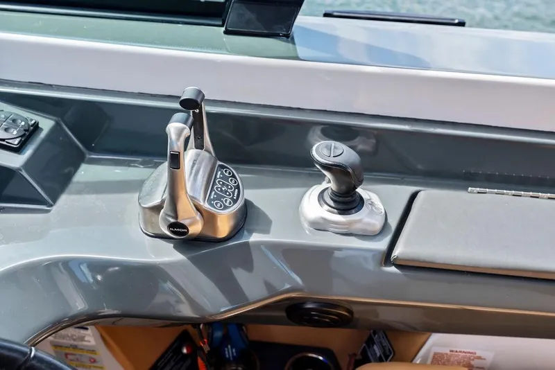 Slide: The Image of Control panel of 2022 Aviara AV40 OB boat with joystick and throttle levers. - 38