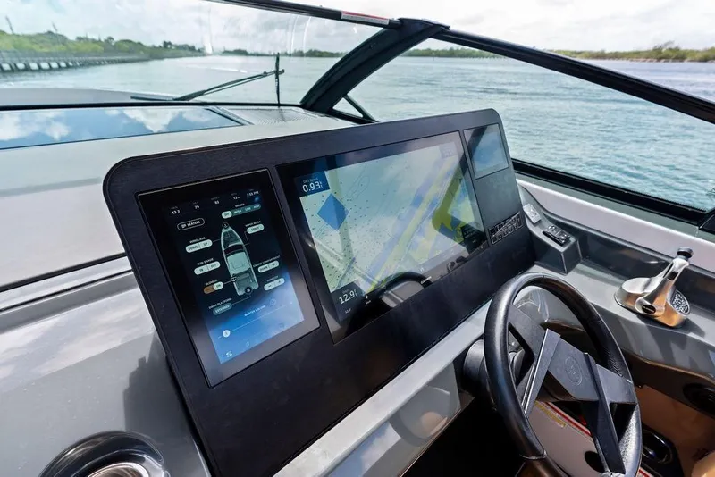 Slide: The Image of 2022 Aviara AV40 OB boat dashboard with advanced navigation screens and steering wheel. - 39