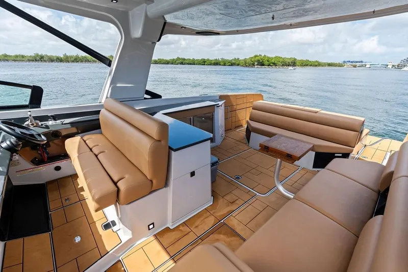 Slide: The Image of Luxurious 2022 Aviara AV40 OB boat interior with tan seating and scenic water view. - 41