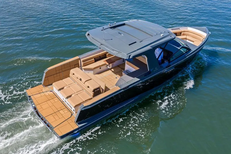 Slide: The Image of 2022 Aviara AV40 OB luxury boat cruising on open water, featuring spacious seating. - 5