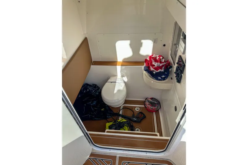 Slide: The Image of 2022 Invincible 39 Open Fisherman boat interior with toilet and storage items. - 12