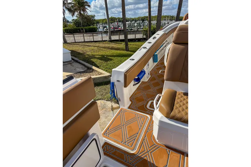 Slide: The Image of 2022 Invincible 39 Open Fisherman boat interior with brown seating and patterned flooring. - 13