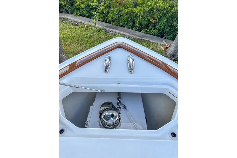Slide: The Image of 2022 Invincible 39 Open Fisherman boat anchor compartment with polished metal fittings. - 16