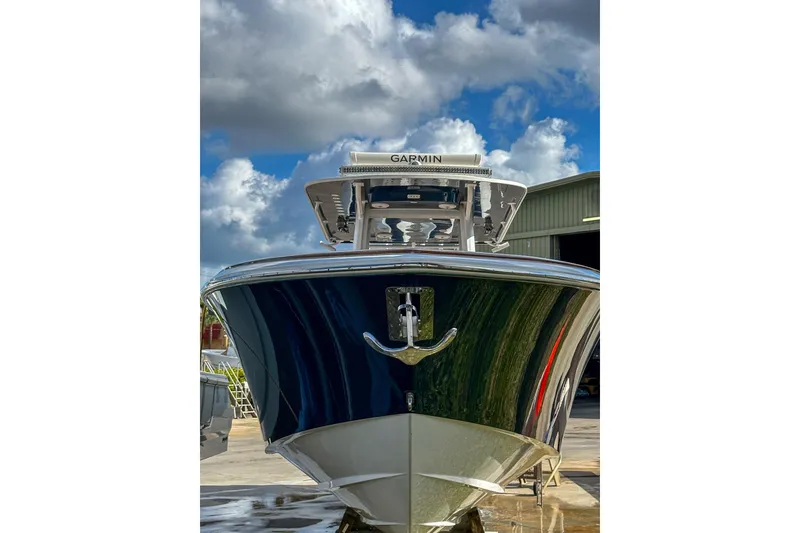 Slide: The Image of 2022 Invincible 39 Open Fisherman boat with Garmin equipment, docked under a cloudy sky. - 21