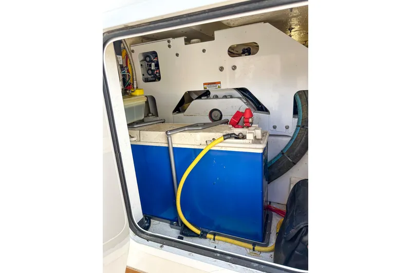 Slide: The Image of 2022 Invincible 39 Open Fisherman boat battery compartment with wiring and components. - 23