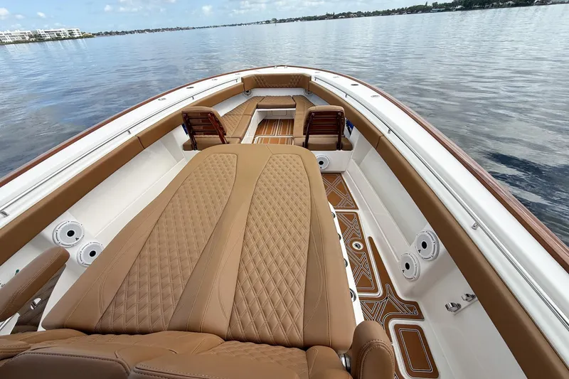 Slide: The Image of Luxurious interior of 2022 Invincible 39 Open Fisherman boat with tan seating and wood accents. - 25