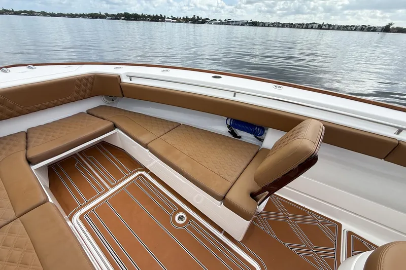 Slide: The Image of 2022 Invincible 39 Open Fisherman boat interior with tan seating and patterned flooring. - 27