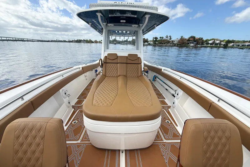 Slide: The Image of 2022 Invincible 39 Open Fisherman boat interior with luxurious tan seating on calm water. - 28