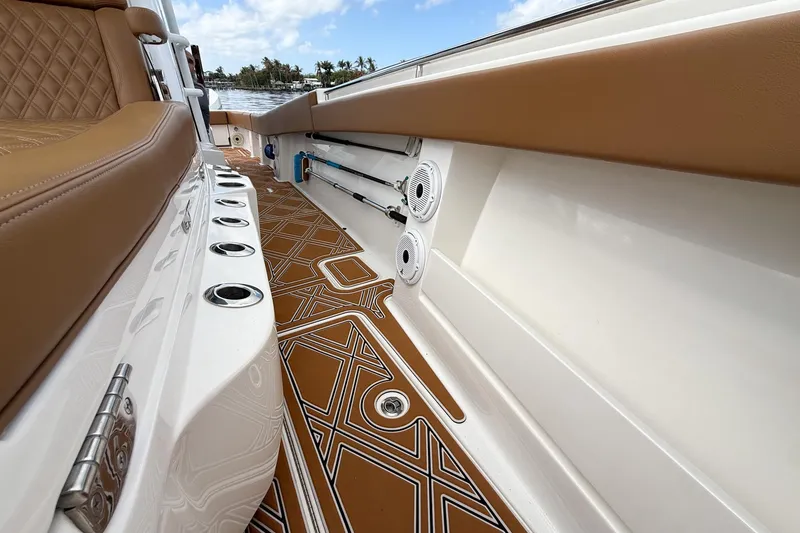 Slide: The Image of 2022 Invincible 39 Open Fisherman boat interior with tan seating and patterned flooring. - 29
