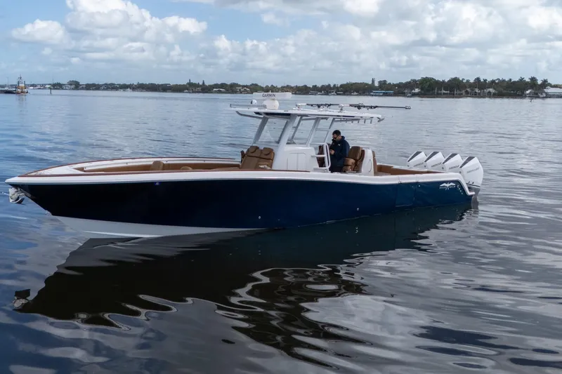 Slide: The Image of 2022 Invincible 39 Open Fisherman boat on calm water under cloudy sky. - 37