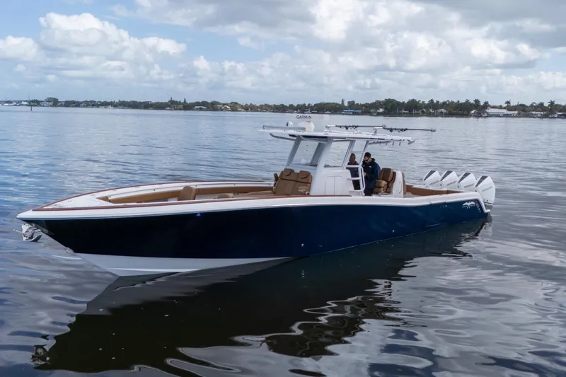 Slide: The Image of 2022 Invincible 39 Open Fisherman boat on calm water under cloudy sky. - 38