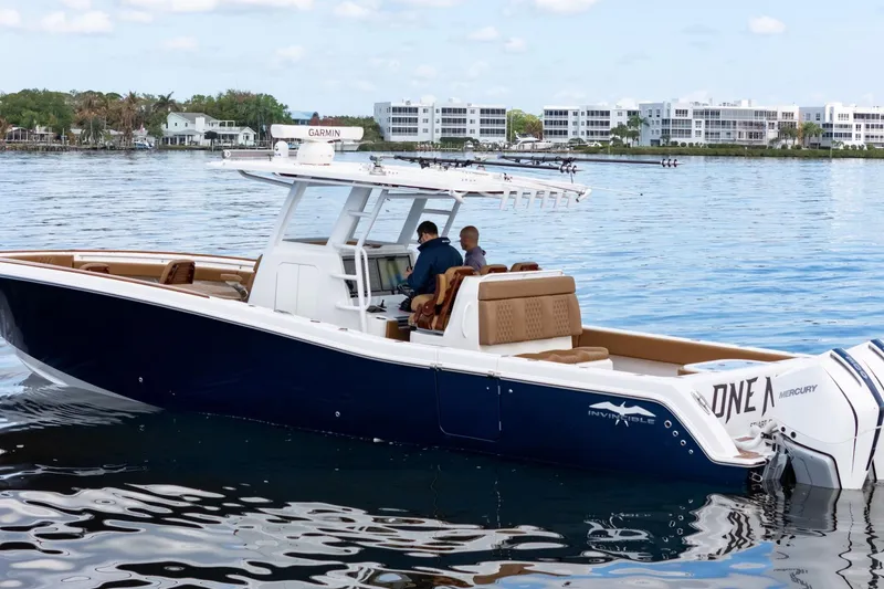 Slide: The Image of 2022 Invincible 39 Open Fisherman boat on calm water, featuring sleek design and powerful engines. - 40