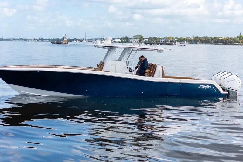 Slide: The Image of 2022 Invincible 39 Open Fisherman boat on calm water, side view. - 41