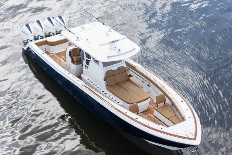 Slide: The Image of 2022 Invincible 39 Open Fisherman boat with four engines on calm water. - 46