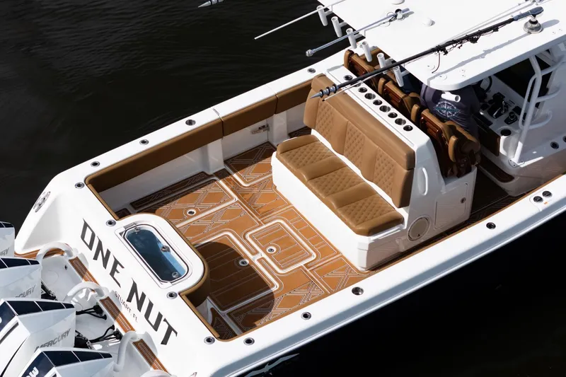 Slide: The Image of 2022 Invincible 39 Open Fisherman boat with tan seating and fishing rods on deck. - 47