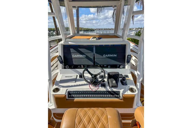 Slide: The Image of 2022 Invincible 39 Open Fisherman boat dashboard with Garmin displays and Mercury controls. - 8