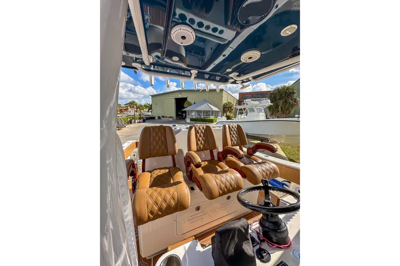 Slide: The Image of Interior of 2022 Invincible 39 Open Fisherman boat with luxurious seating and steering wheel. - 9
