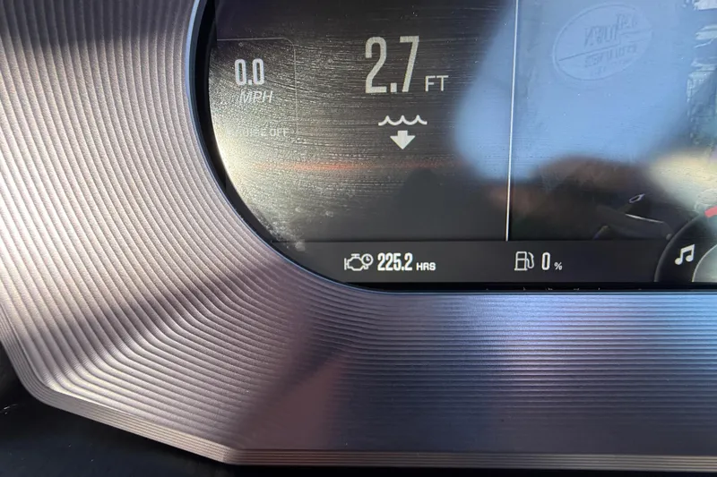 Slide: The Image of 2023 MasterCraft X22 dashboard display showing depth, engine hours, and fuel level. - 11