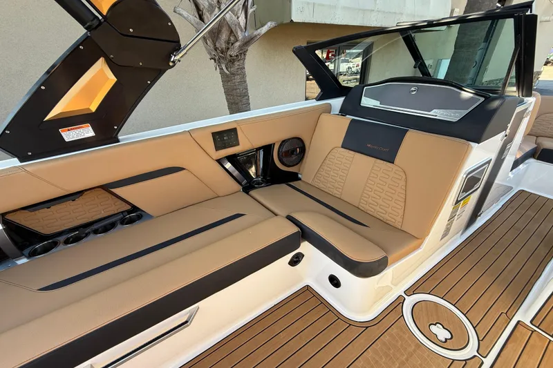 Slide: The Image of 2023 MasterCraft X22 boat interior with tan seating and modern design. - 8