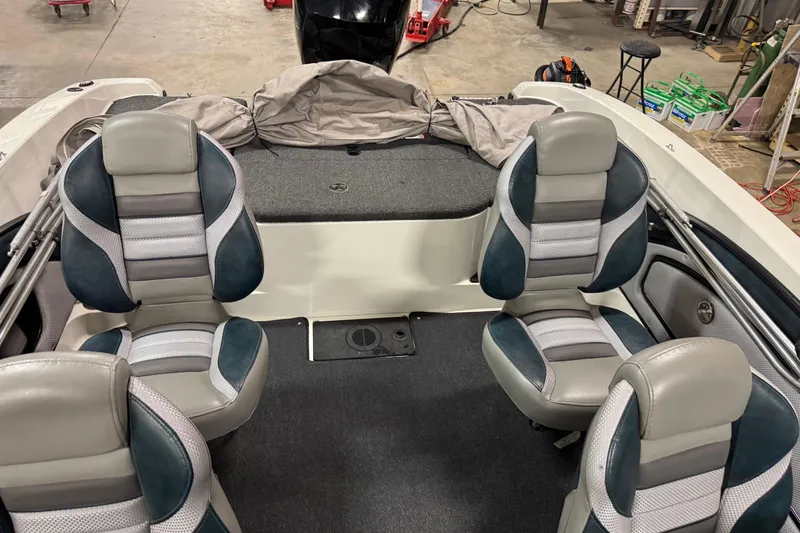 Slide: The Image of 2023 Ranger 1850MS boat interior with four cushioned seats in a workshop setting. - 13