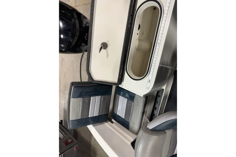 Slide: The Image of 2023 Ranger 1850MS boat interior with storage compartments and seating. - 16
