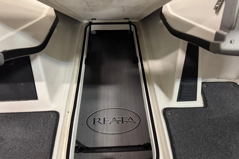 Slide: The Image of 2023 Ranger 1850MS boat interior with Reata logo, featuring storage compartment. - 17