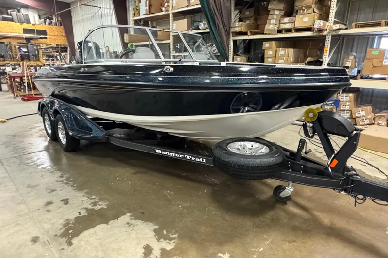 Slide: The Image of 2023 Ranger 1850MS boat on trailer in warehouse setting. - 2