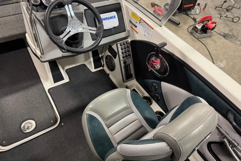 Slide: The Image of 2023 Ranger 1850MS boat interior with steering wheel and control panel. - 6