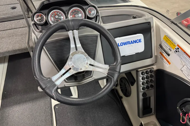 Slide: The Image of 2023 Ranger 1850MS boat dashboard with steering wheel and Lowrance display. - 7
