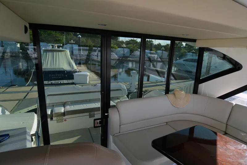 Slide: The Image of Interior view of 2018 Regal 46 Sport Coupe yacht with docked boats outside. - 10