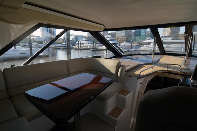 Slide: The Image of Interior of 2018 Regal 46 Sport Coupe yacht with marina view through large windows. - 13