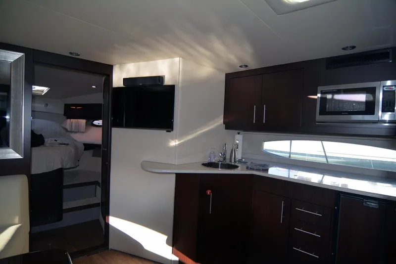 Slide: The Image of Interior of 2018 Regal 46 Sport Coupe yacht with modern kitchen and cozy bedroom. - 15