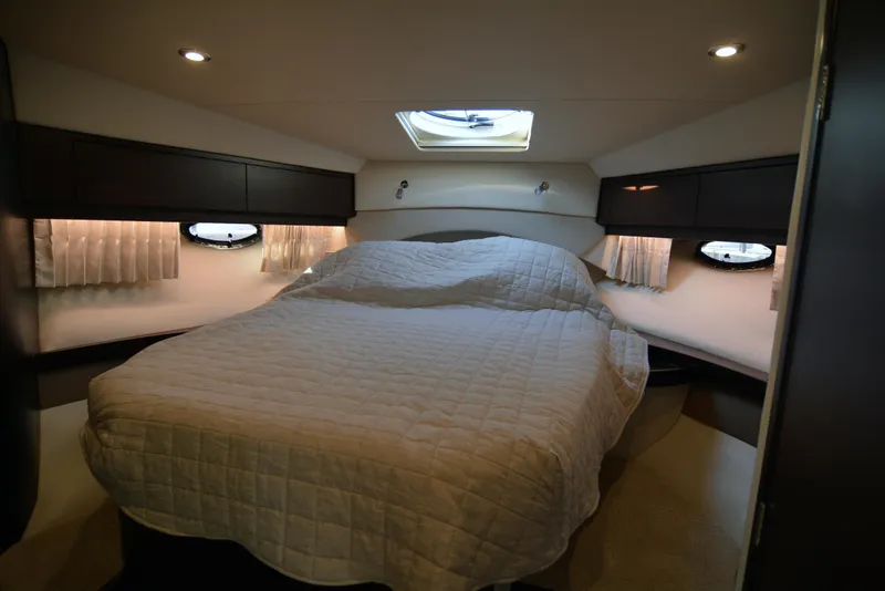 Slide: The Image of Luxurious cabin interior of 2018 Regal 46 Sport Coupe with cozy bed and ambient lighting. - 18