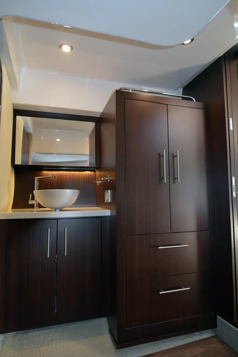 Slide: The Image of 2018 Regal 46 Sport Coupe interior with modern cabinetry and sleek sink design. - 21