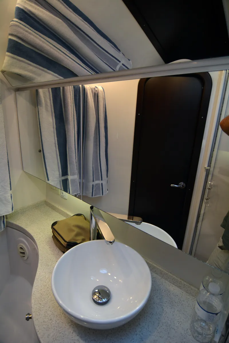 Slide: The Image of 2018 Regal 46 Sport Coupe bathroom with modern sink and mirror. - 23