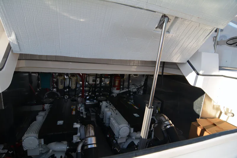 Slide: The Image of Engine compartment of 2018 Regal 46 Sport Coupe, showcasing dual engines and mechanical components. - 26