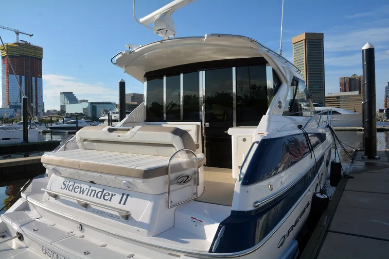 Slide: The Image of 2018 Regal 46 Sport Coupe yacht docked at marina, rear view. - 3