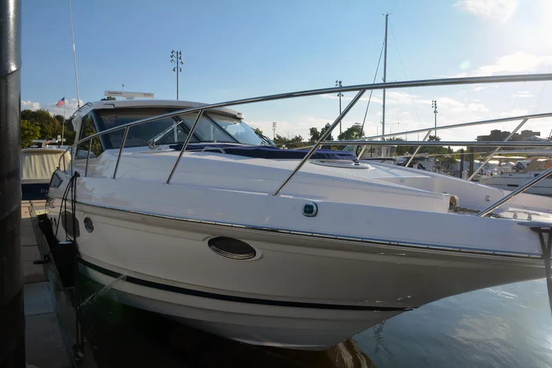 Slide: The Image of 2018 Regal 46 Sport Coupe yacht docked at marina, sleek white design. - 5