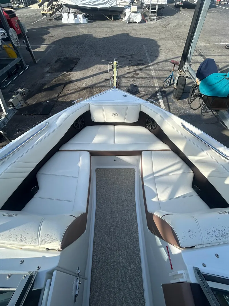Slide: The Image of 2012 Cobalt 210 WSS boat with spacious white seating and carpeted deck. - 1