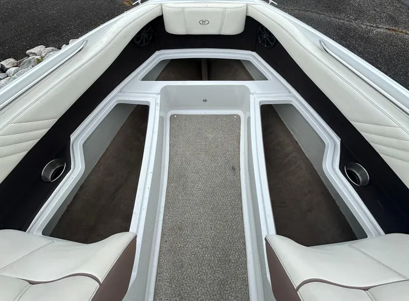 Slide: The Image of 2012 Cobalt 210 WSS boat interior with white seating and carpeted flooring. - 2