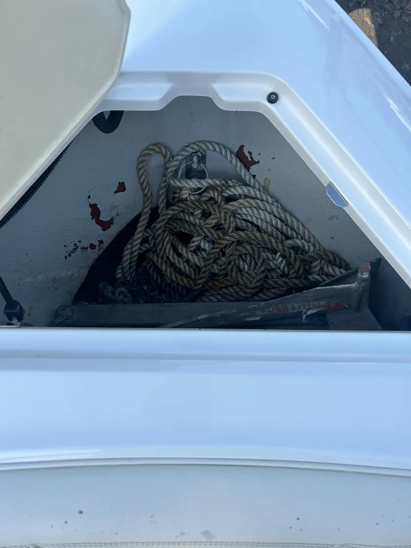 Slide: The Image of Storage compartment of a 2012 Cobalt 210 WSS boat with coiled rope inside. - 3