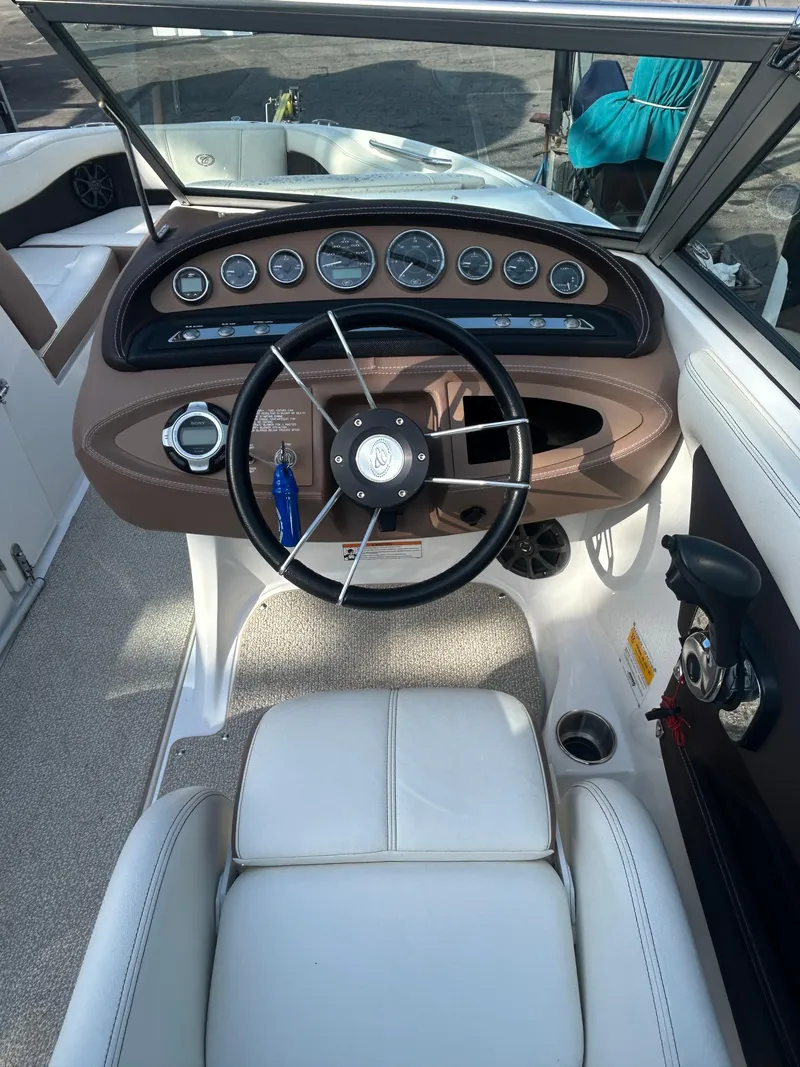 Slide: The Image of Interior view of 2012 Cobalt 210 WSS boat dashboard with steering wheel and gauges. - 7
