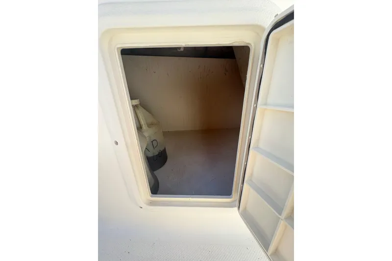 Slide: The Image of Storage compartment of 2013 Hurricane SunDeck Sport 188 OB boat, partially open. - 10