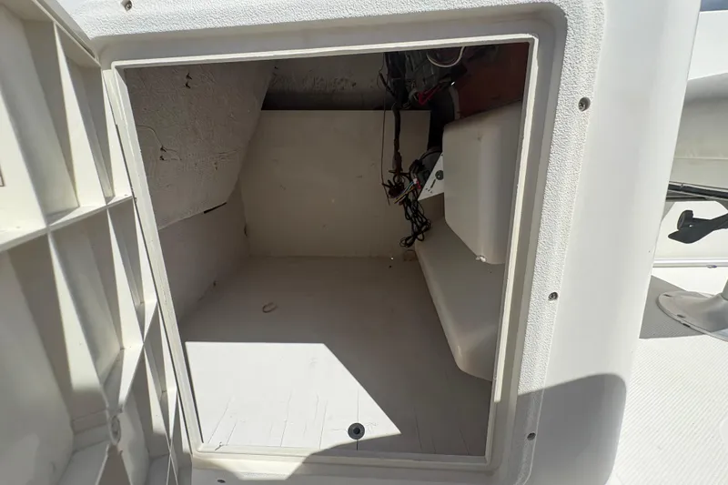 Slide: The Image of Open storage compartment on a 2013 Hurricane SunDeck Sport 188 OB boat. - 11